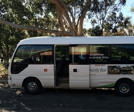 White Serpentine Jarrahdale Shire community bus with door open, parked under trees and available to book hourly on SpacetoCo