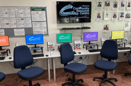Computer lab with multiple monitors and desk chairs at Broome Community Resource Centre, bookable on SpacetoCo