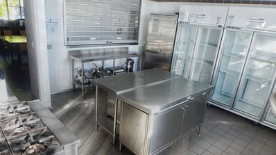 Stainless steel commercial kitchen with prep tables and industrial fridges at Perth City Farm, bookable on SpacetoCo